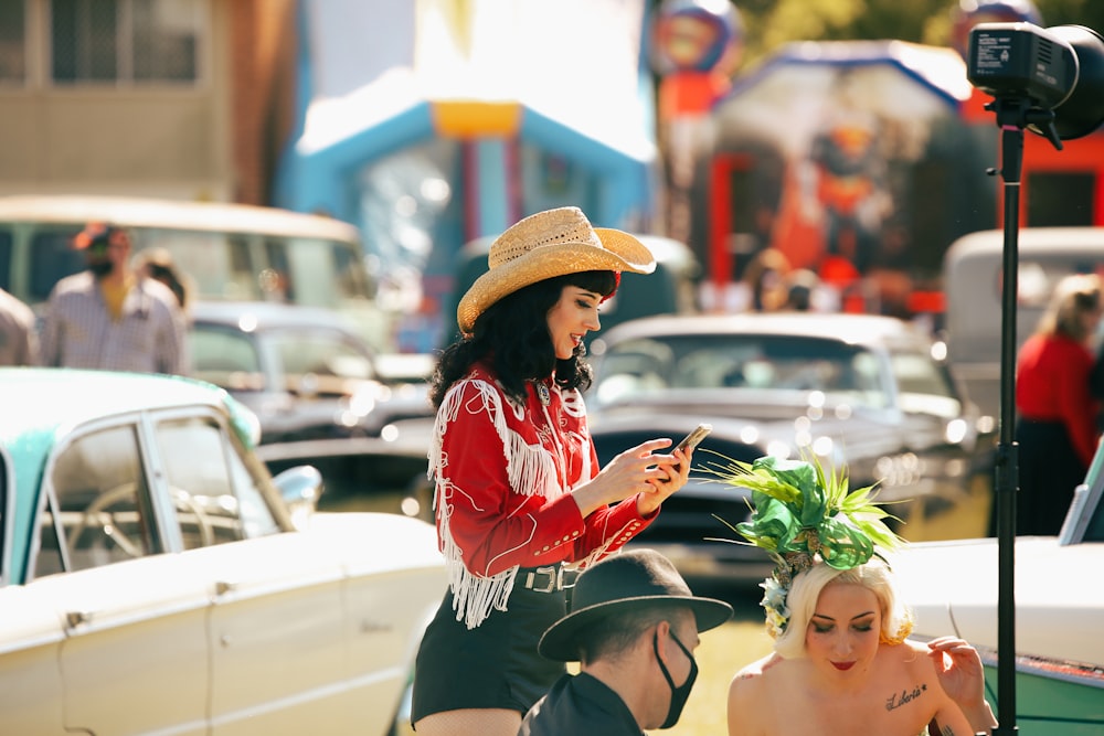 woman in black and red long sleeve shirt and black skirt sitting on white car during