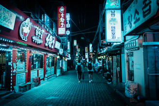 A lively group of travelers dressed in themed gear exploring a neon-lit street in Seoul at night.