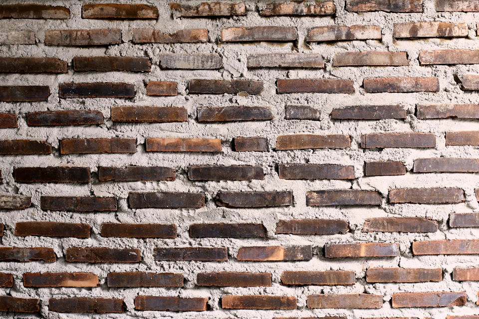 Close-up view of brick wall featuring unique textures and colors in orderly arrangement