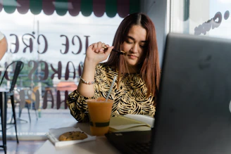 woman in black and white stripe shirt sitting on chair