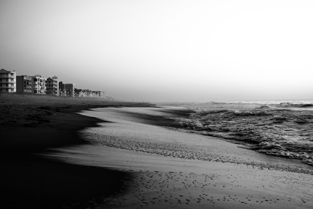 grayscale photo of beach and buildings