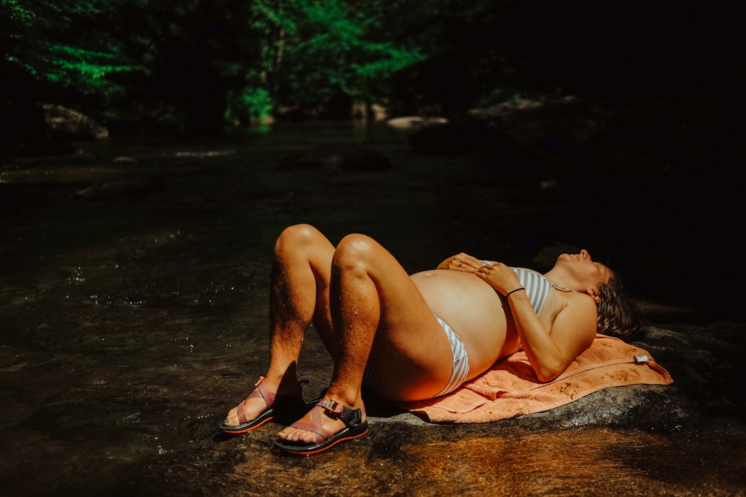 woman in white bikini lying on ground