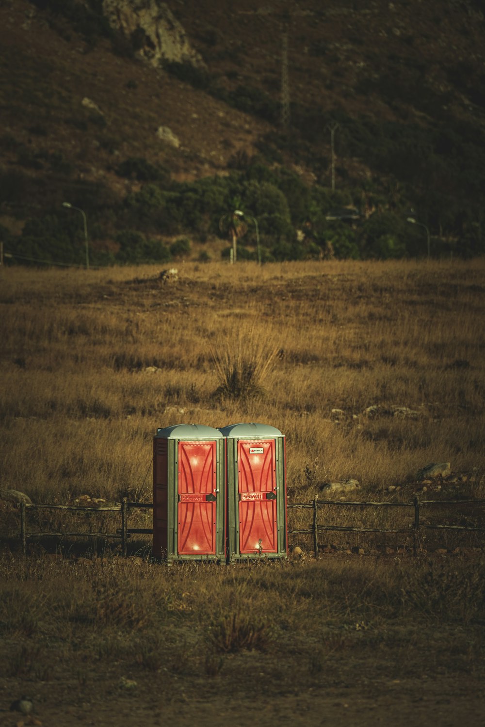 red and white metal container on green grass field