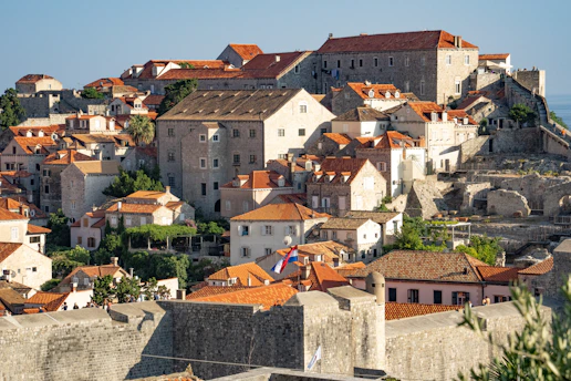 Historic stone buildings and narrow streets bathed in warm afternoon light in Zocca