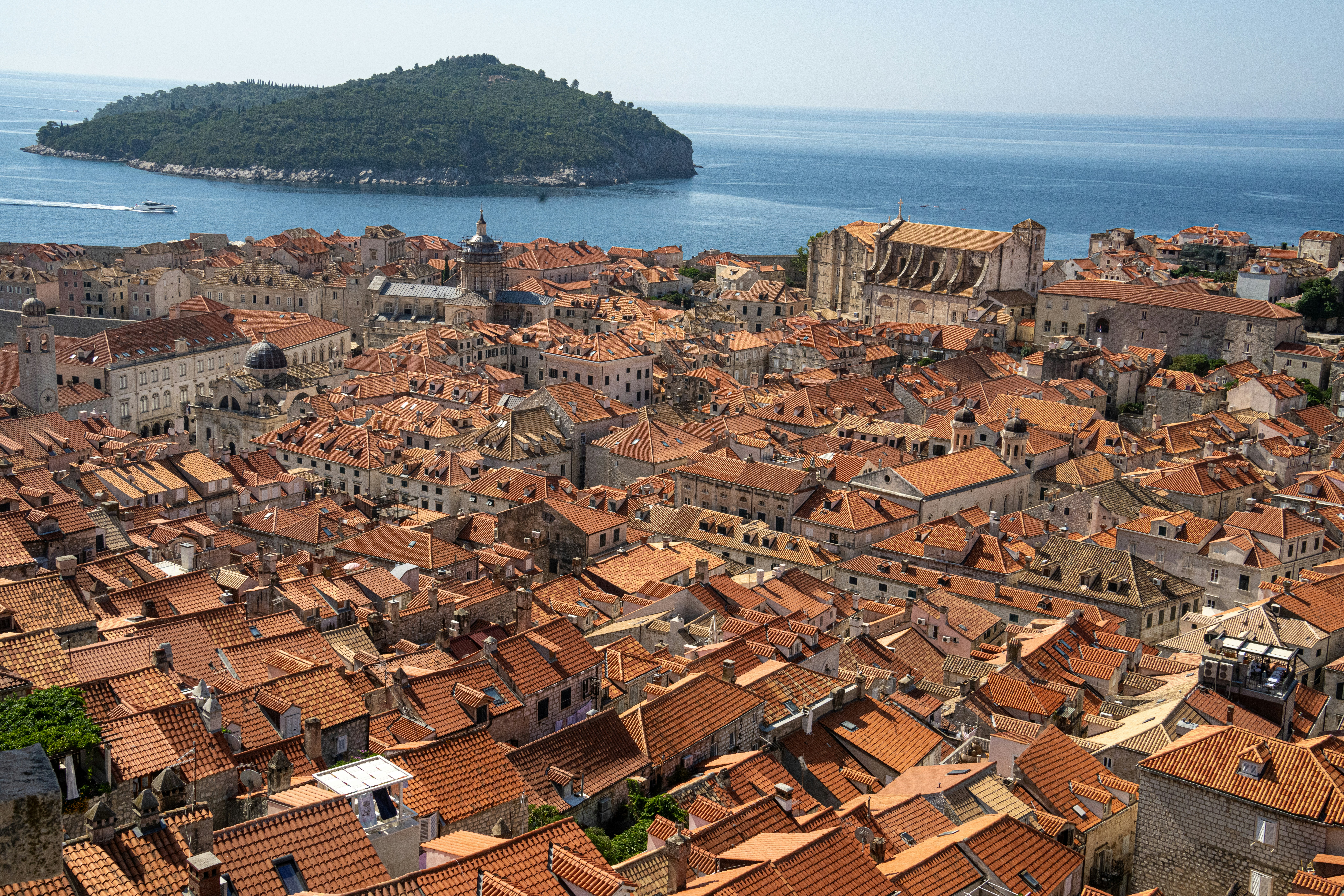Aerial view of city near body of water during daytime