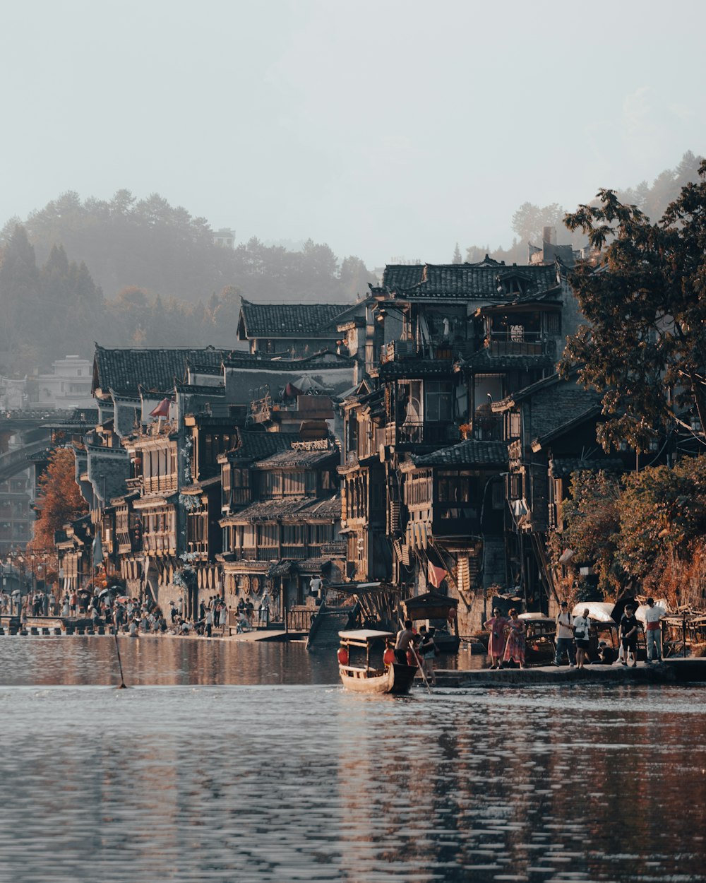 people on boat on water near brown concrete building during daytime