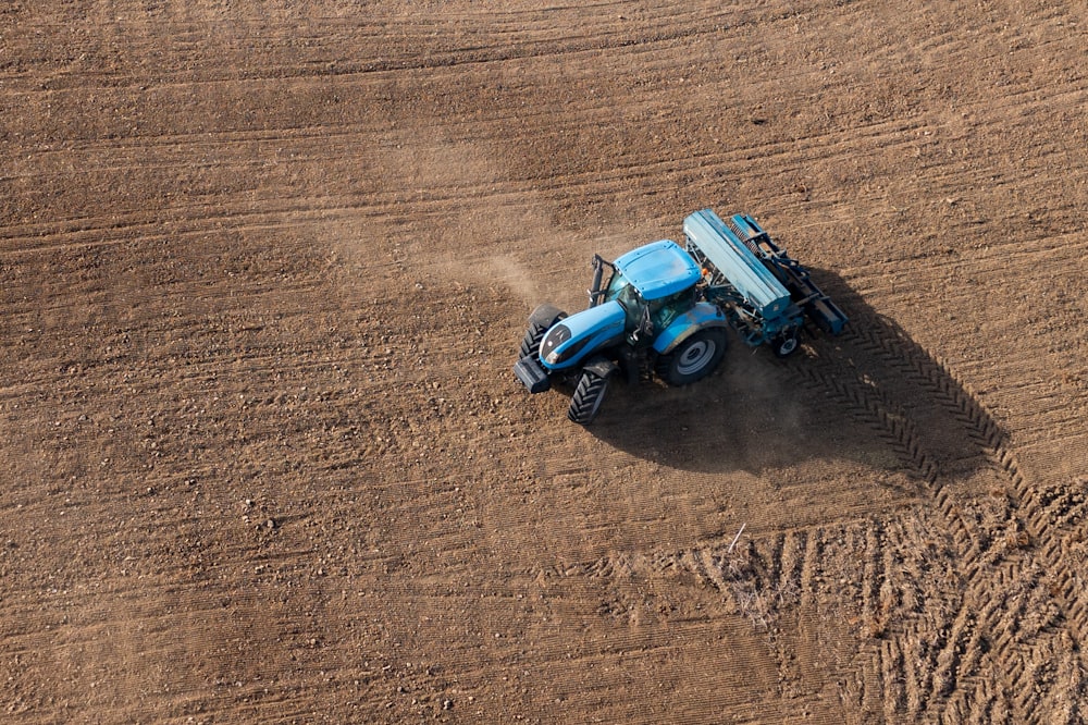 blue and black toy car on brown sand