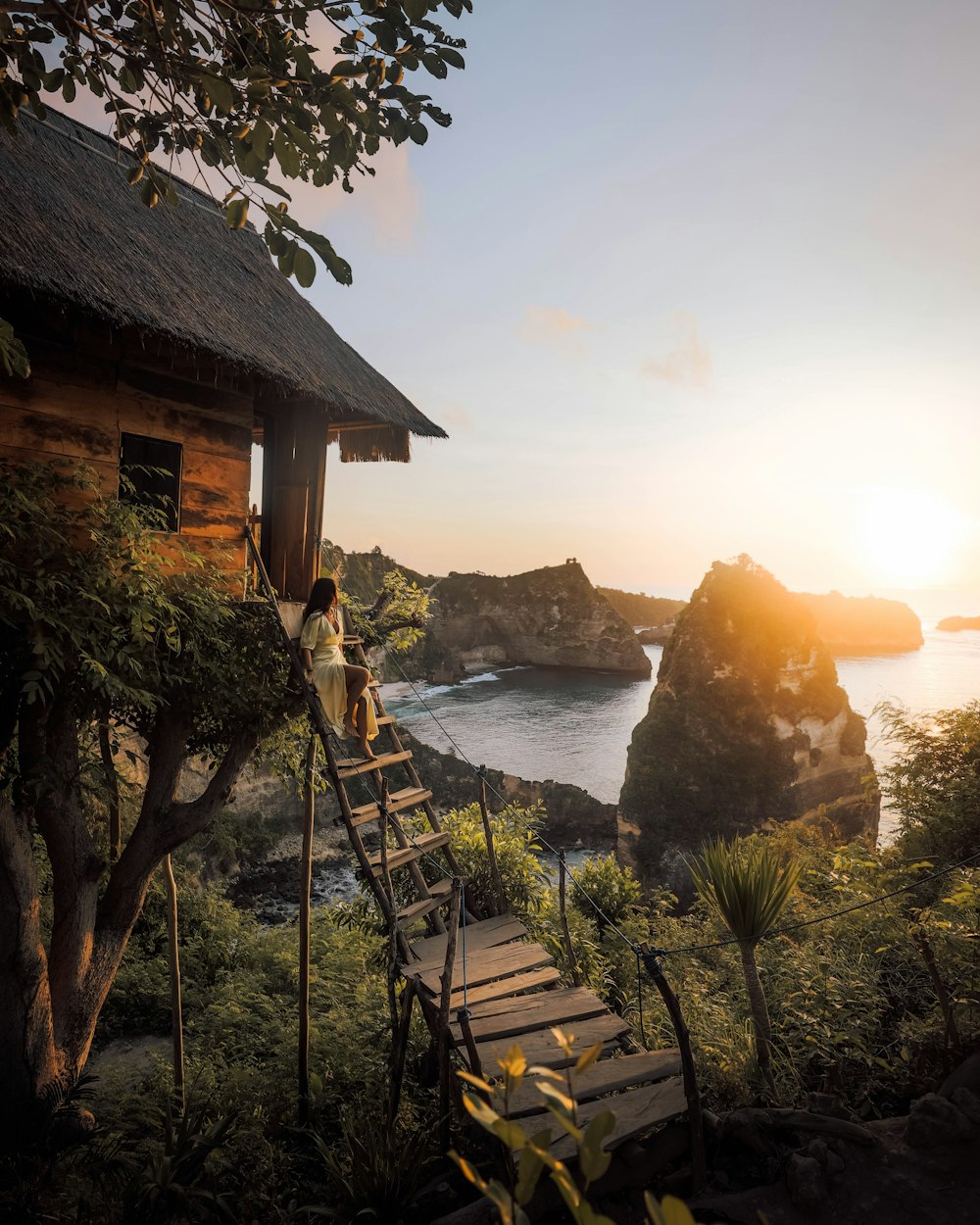 brown wooden stairs near body of water during sunset