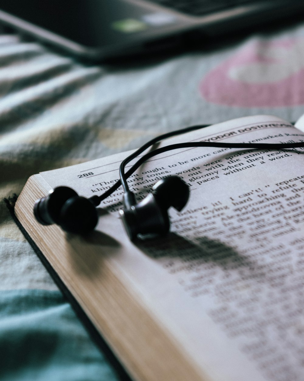 black earbuds on white book page