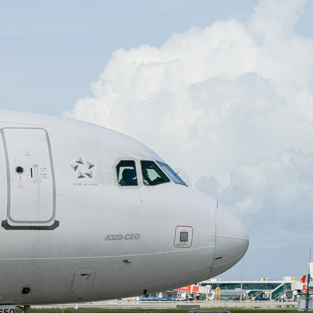 white passenger plane under white clouds during daytime