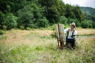 man in white shirt sitting on brown wooden chair