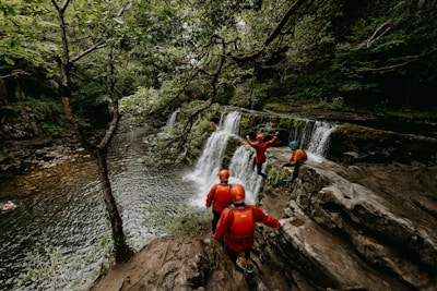 a group of people standing on top of a waterfall