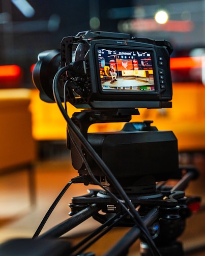 black dslr camera on black stand