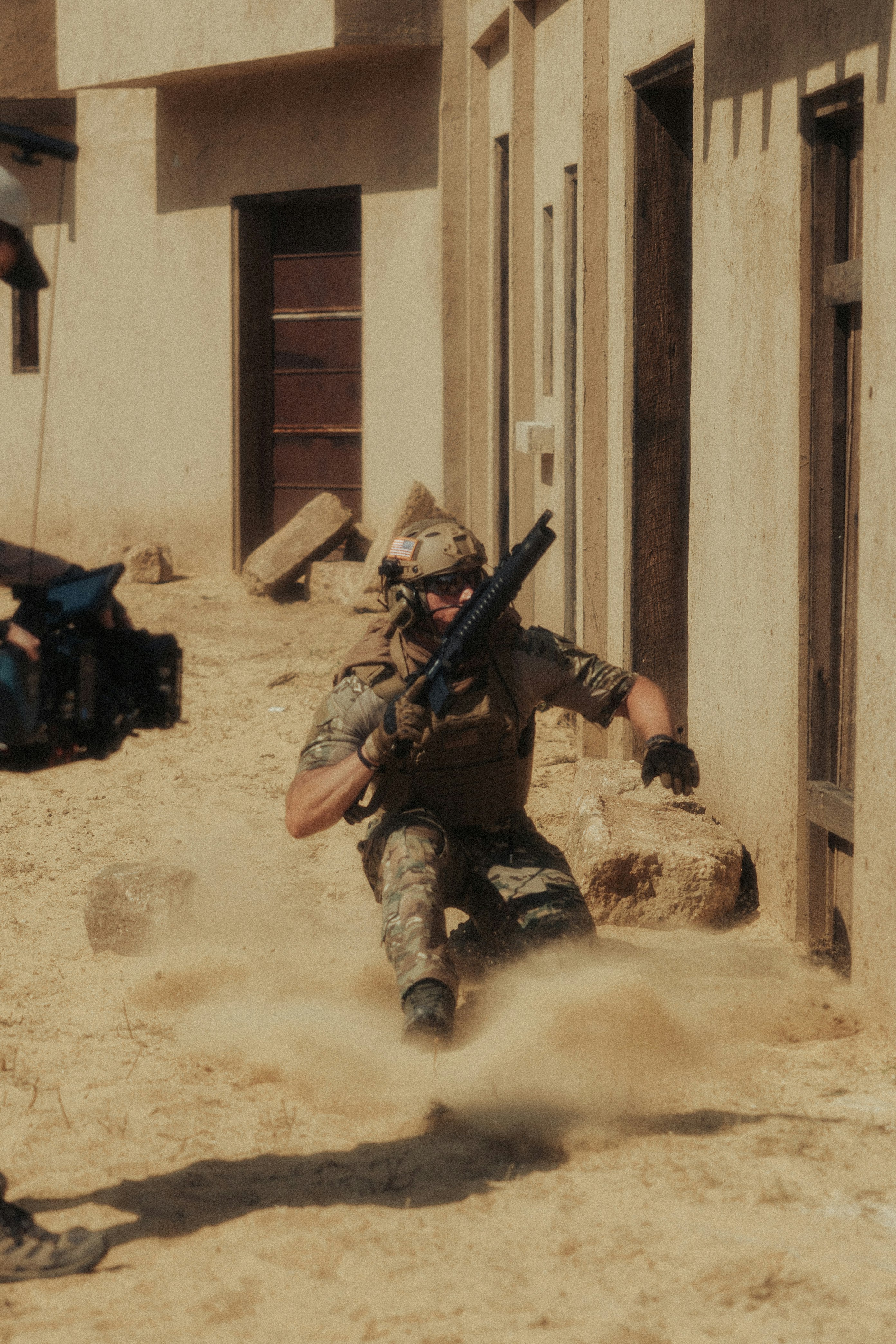 man in black and brown camouflage uniform holding rifle