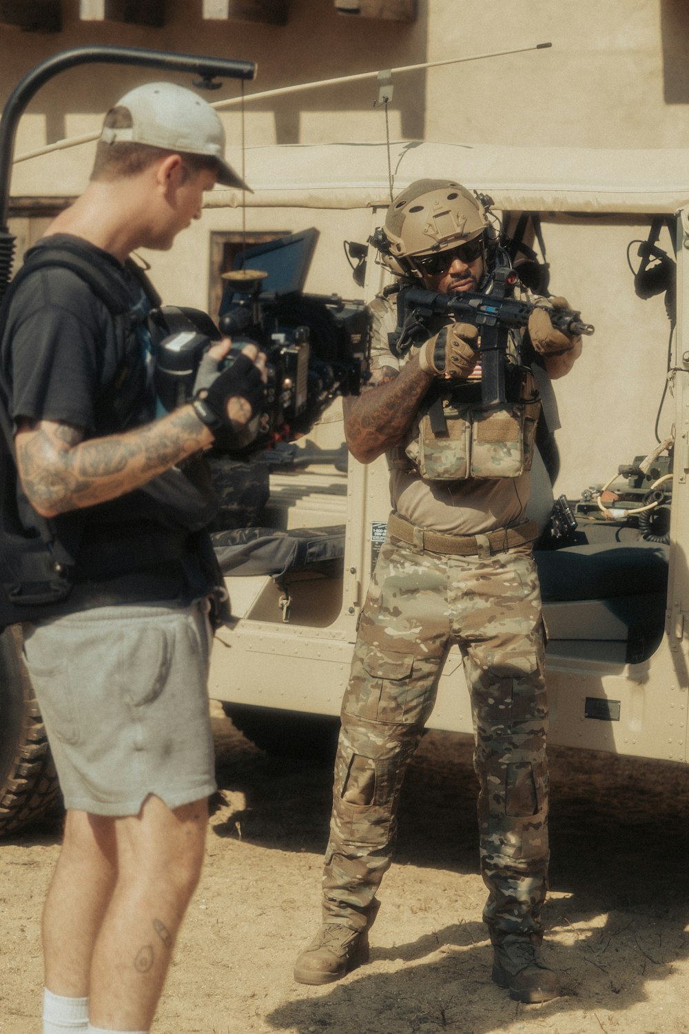 man in green camouflage uniform holding black dslr camera