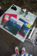 Artistic shot of vinyl records and streetwear laid out on a graffiti-covered table.