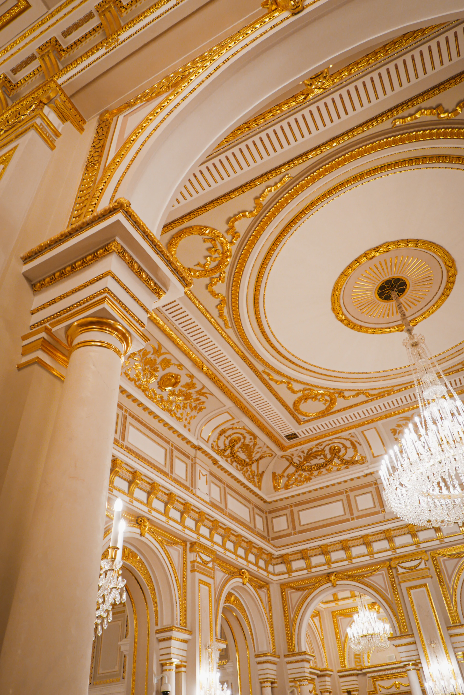 Close-up of luxurious interior finishing with golden accents and modern architectural details in a commercial building.