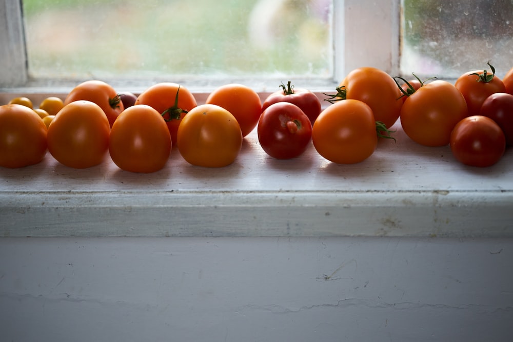 orange tomato on white wooden table