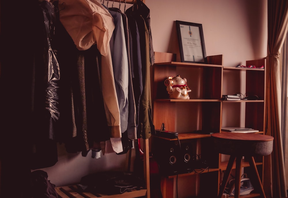 clothes hanged on black metal rack