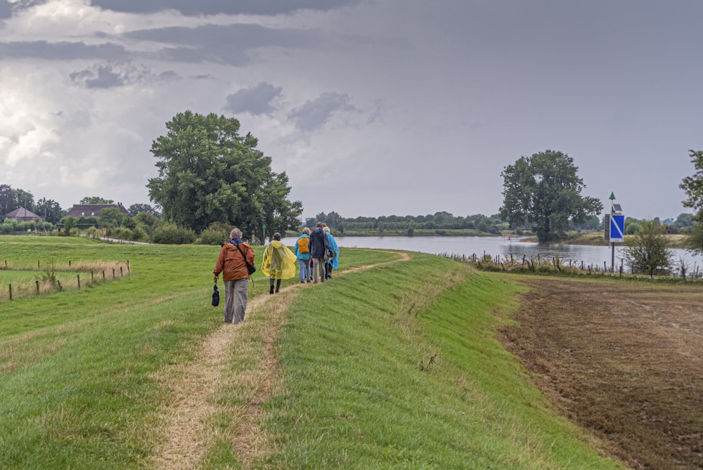 people walking on green grass field during daytime