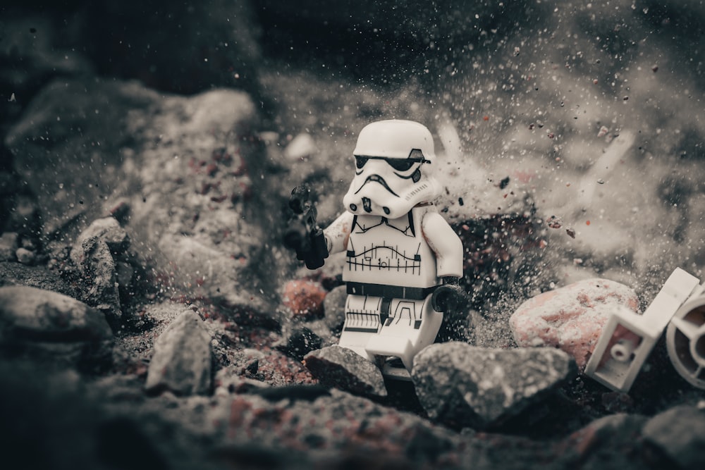 white and black skeleton figurine on gray rock