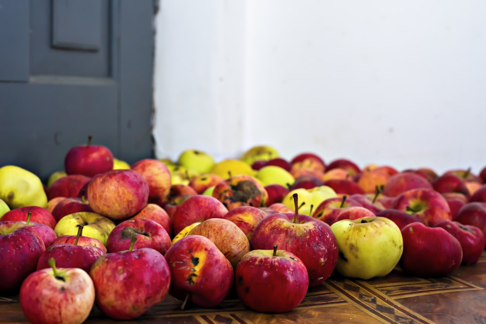 red and green apples on brown woven mat