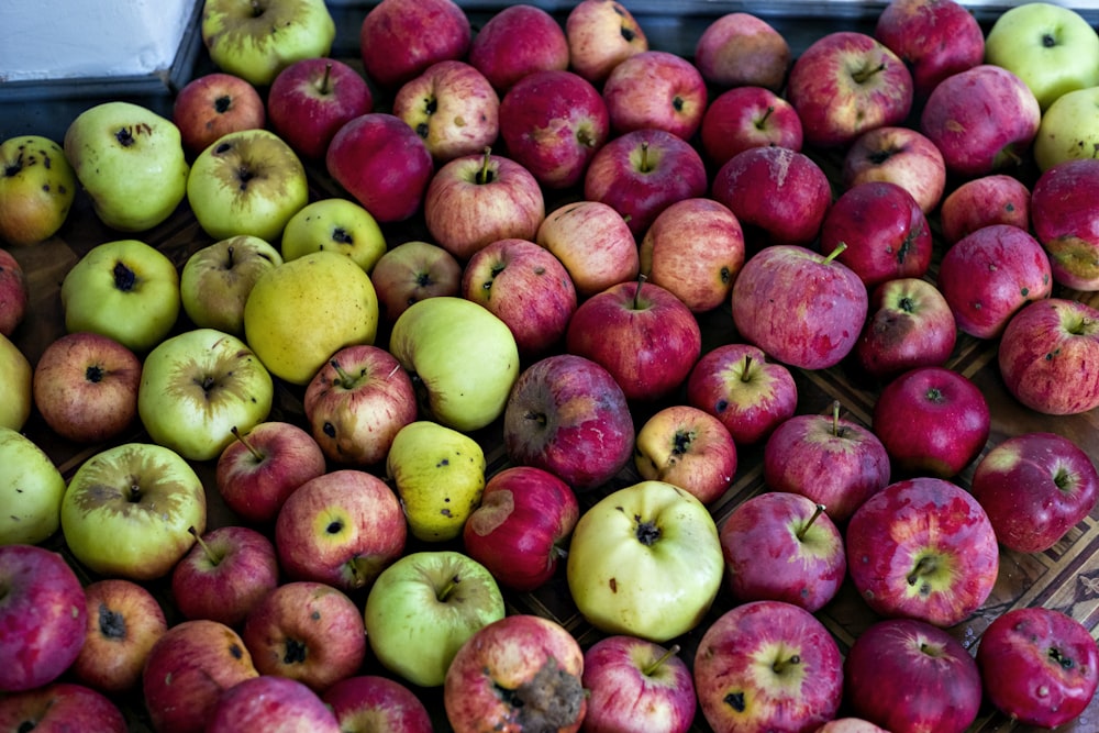 red and green apples on blue plastic crate