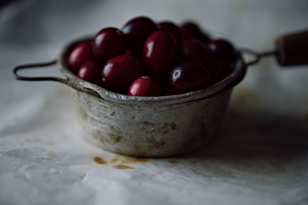 red cherries in stainless steel bowl