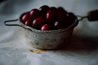 red cherries in stainless steel bowl cranberry zoom background