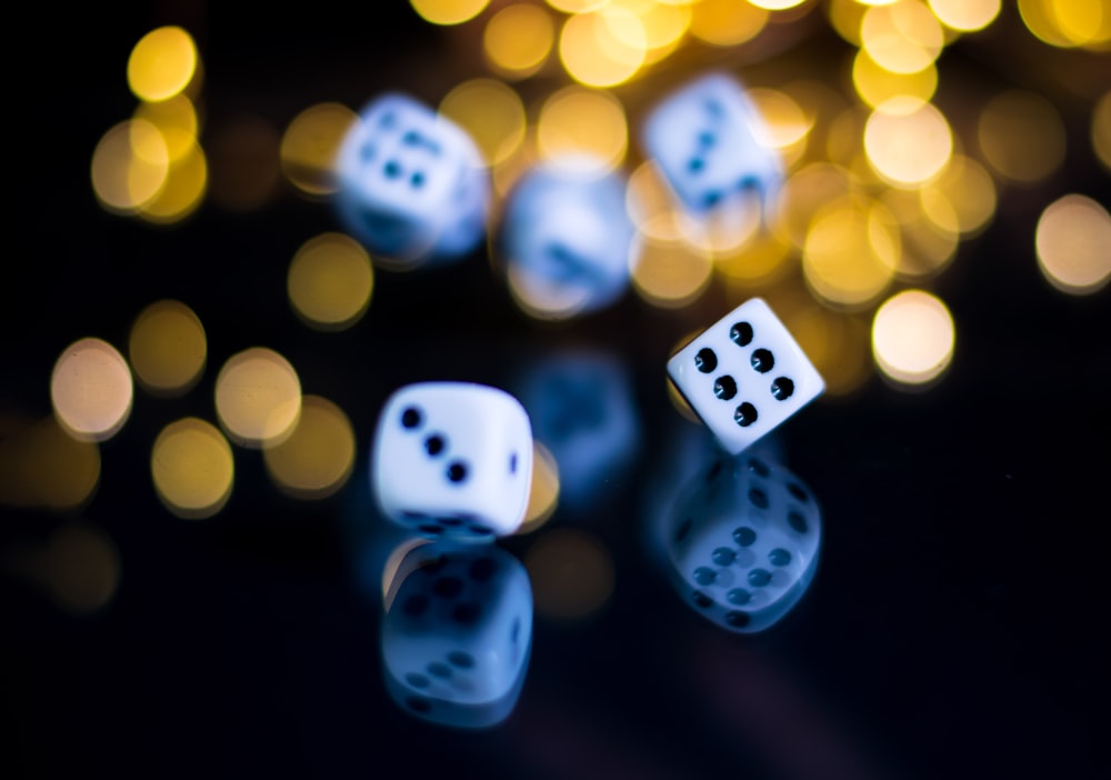 white and black dice with yellow and black bokeh lights