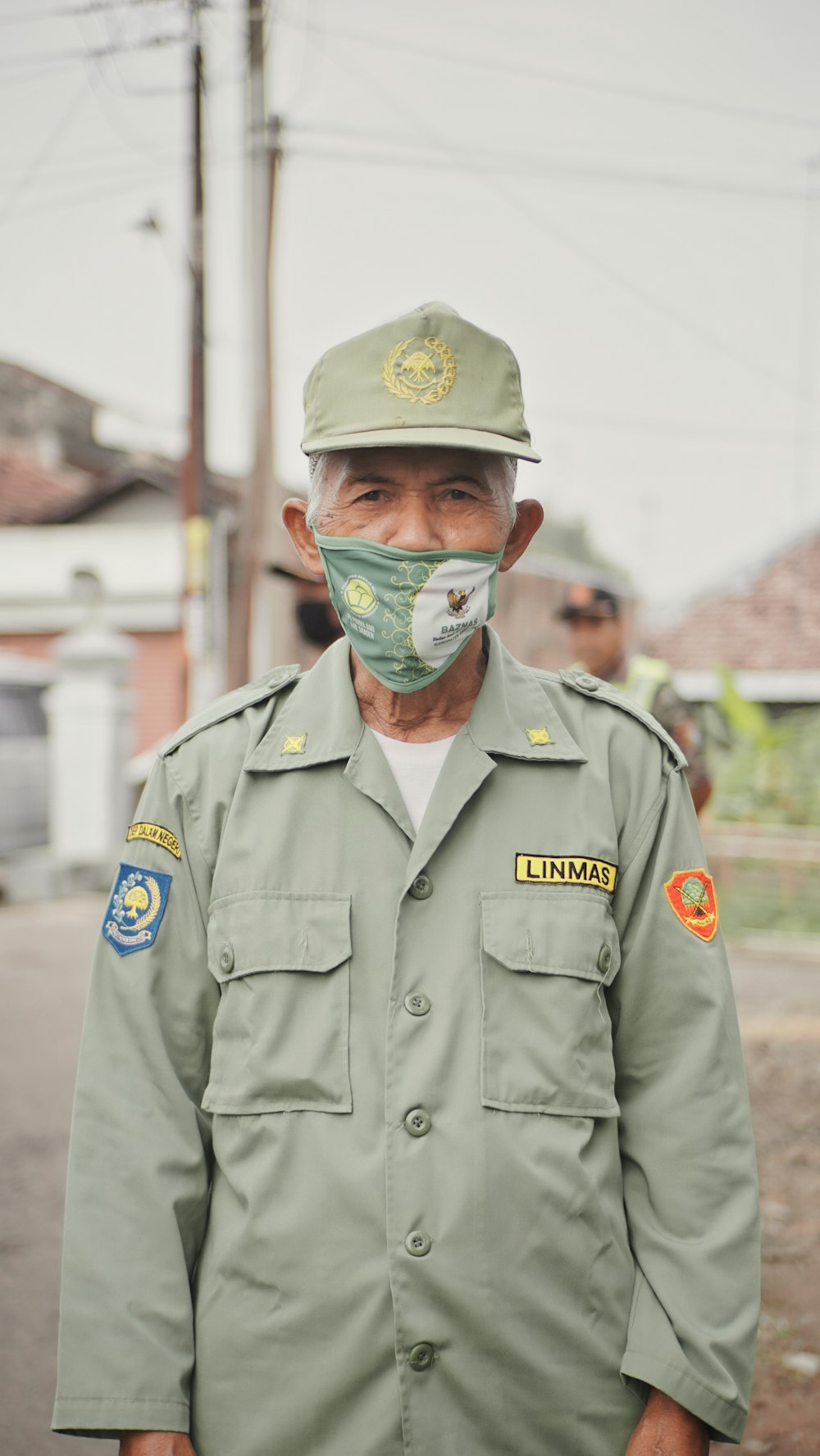 man in black leather jacket wearing green mask