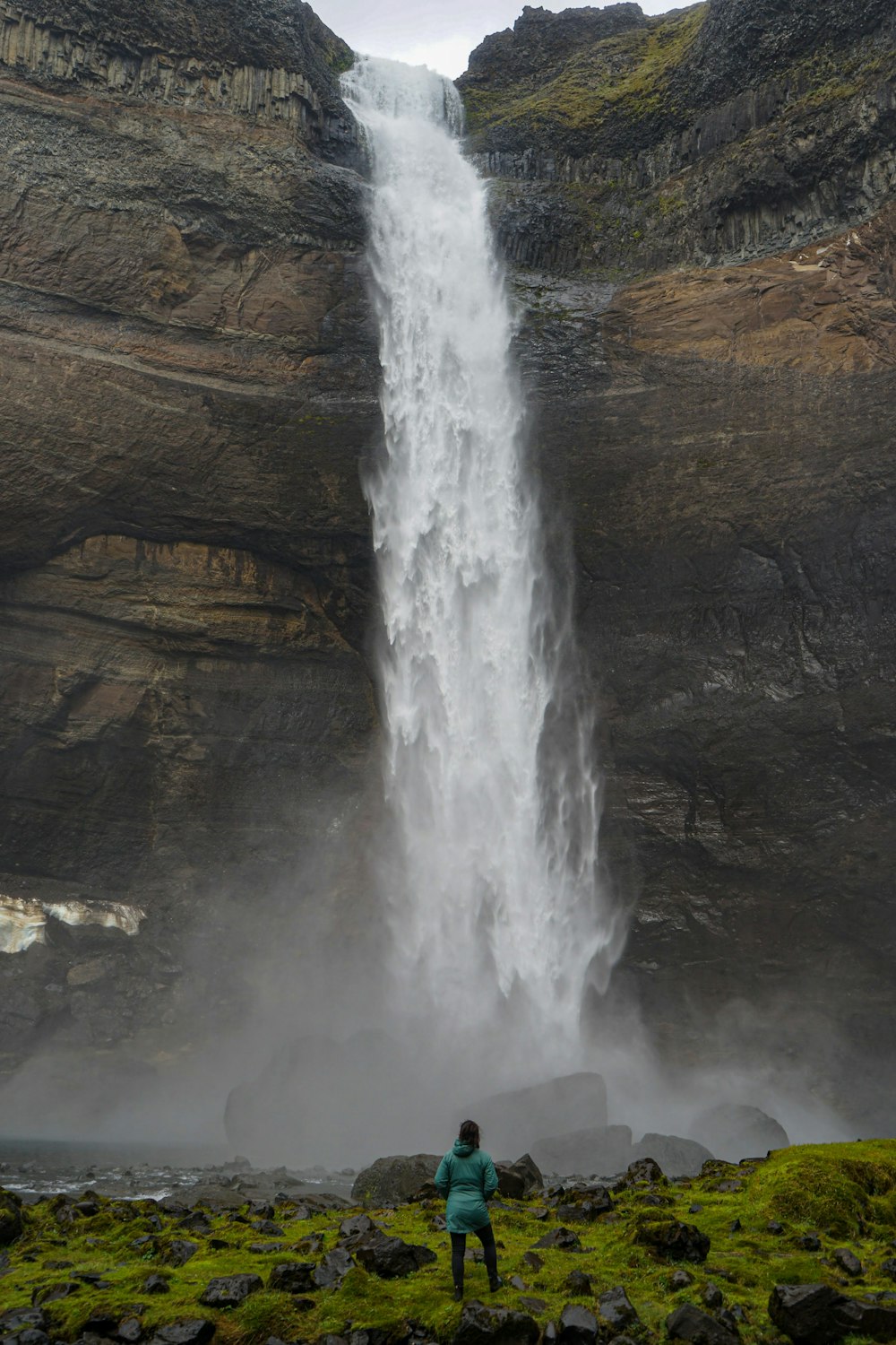 L'acqua cade sulla montagna rocciosa marrone