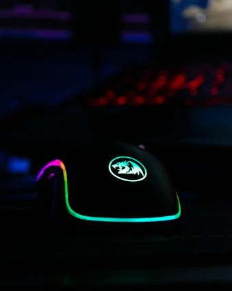 A vibrant gaming mouse and keyboard set illuminated with RGB lighting