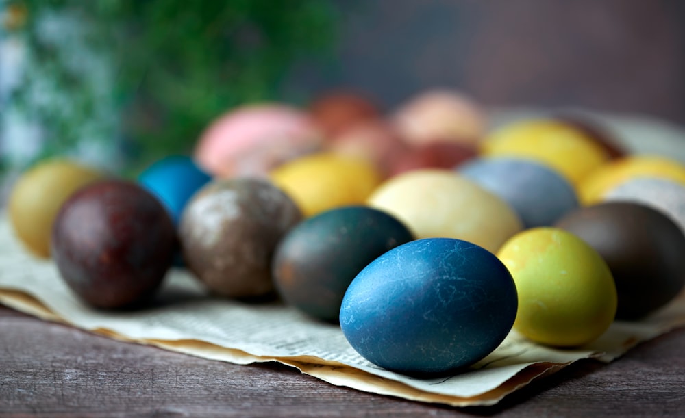 blue yellow and red egg on brown wooden tray