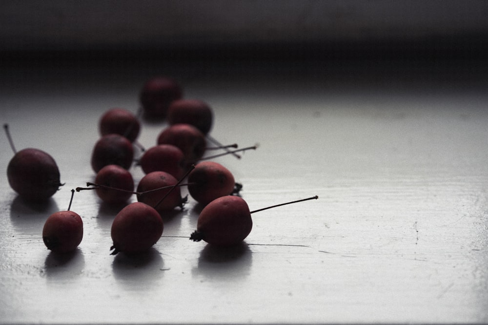 red round fruits on white table