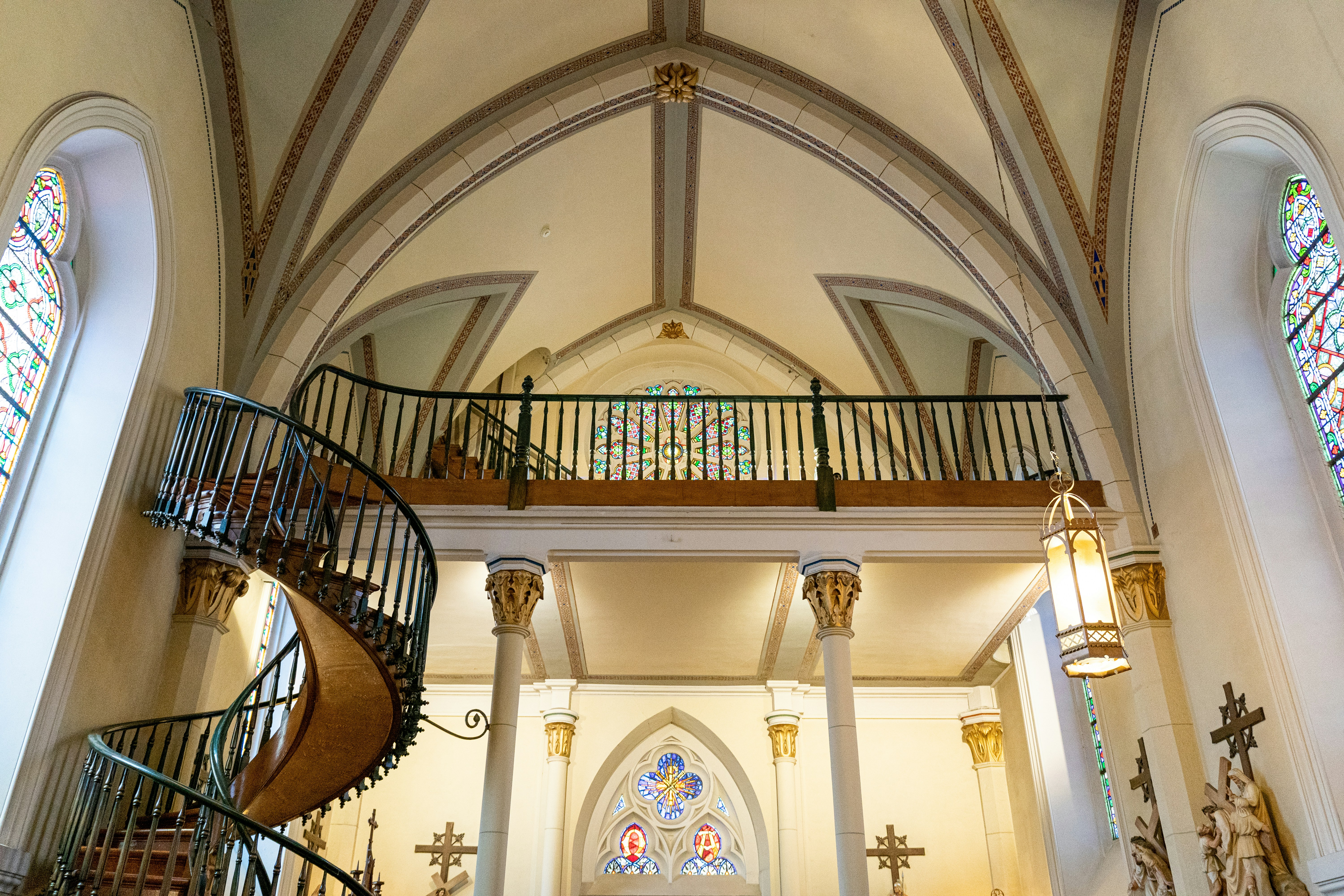 white and brown concrete building, The miraculous staircase attributed to St. Joseph at the Loretto Chapel in Santa Fe, NM