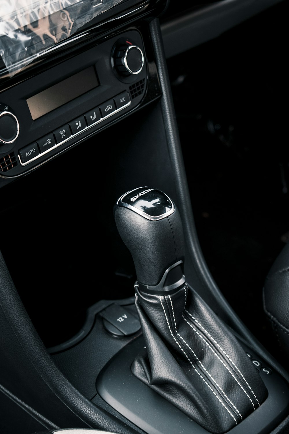 black and silver car gear shift lever