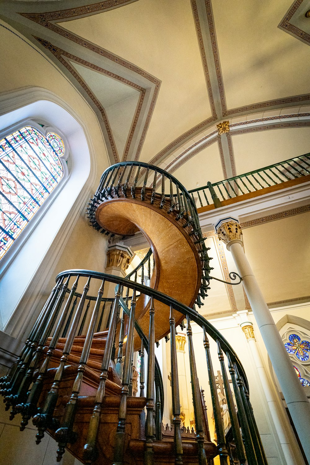 brown wooden spiral staircase with black metal railings