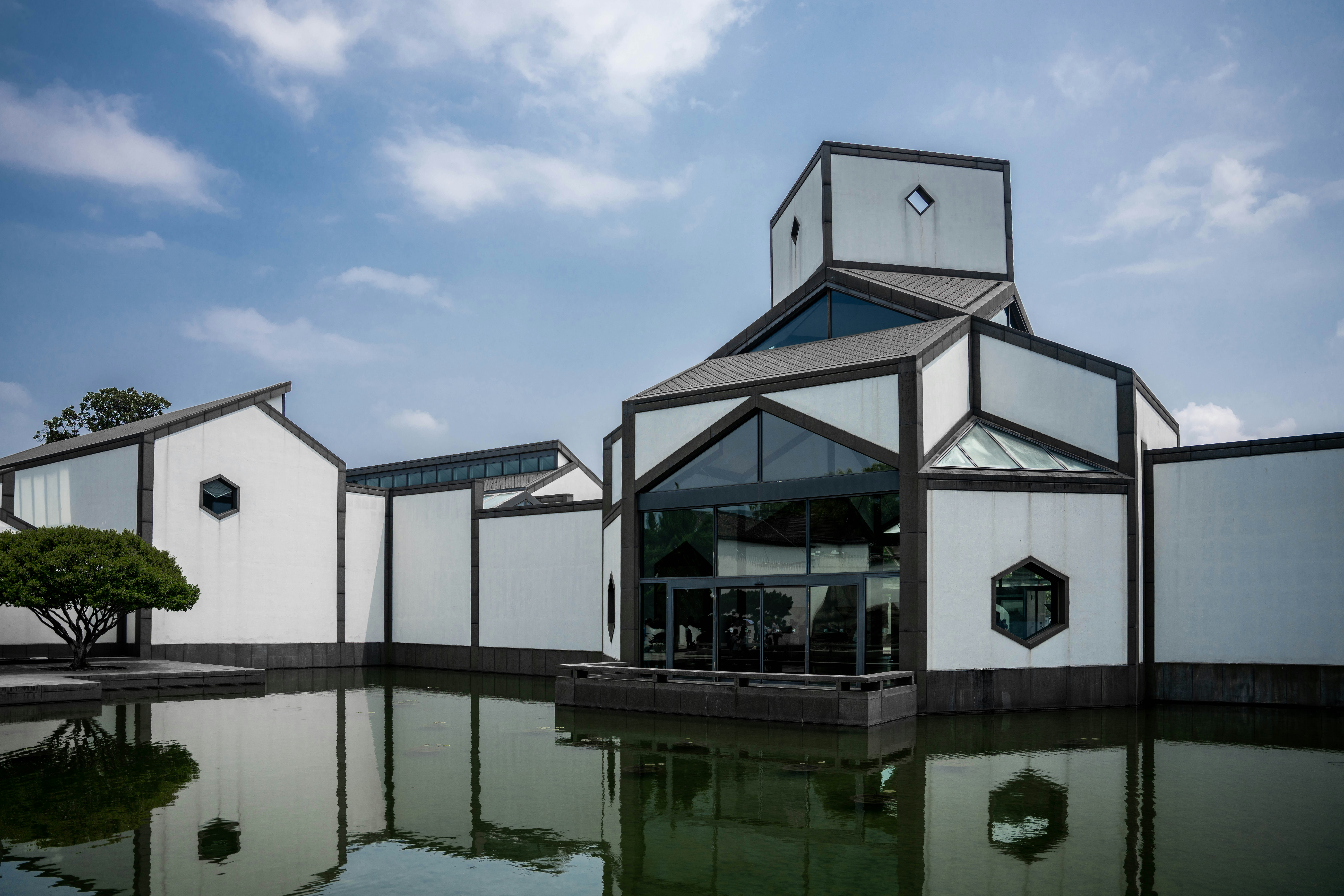 white and blue concrete building near body of water during daytime