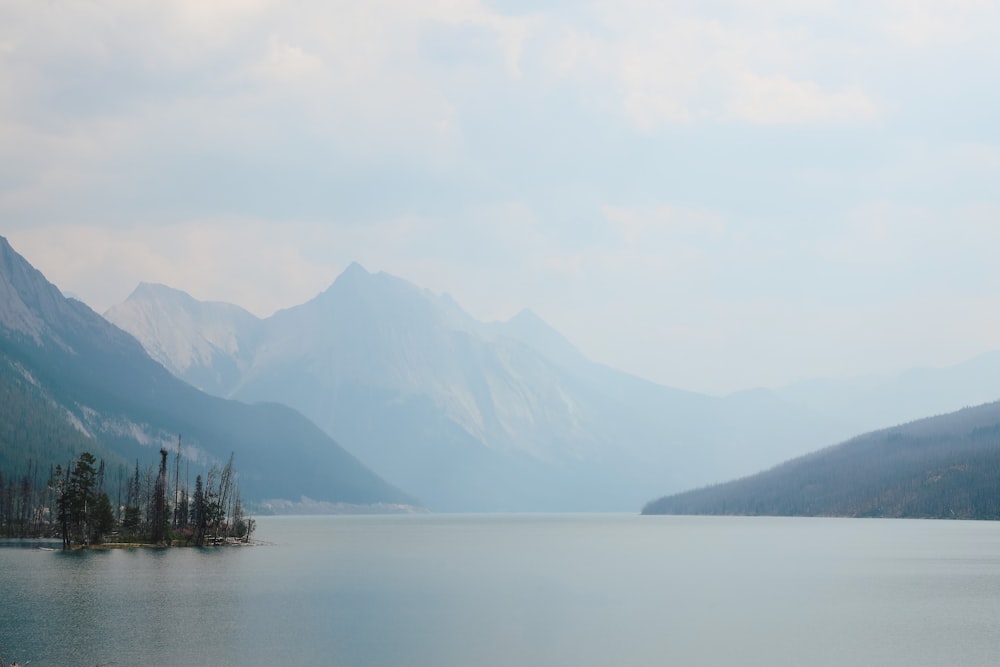 body of water near mountain during daytime