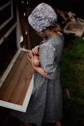 A child carefully collecting eggs from a cozy chicken coop.