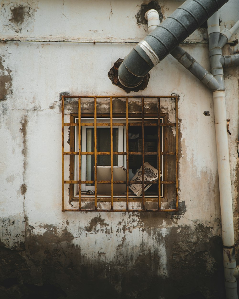 brown wooden window frame on white concrete wall