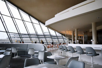 people sitting on white chairs inside building