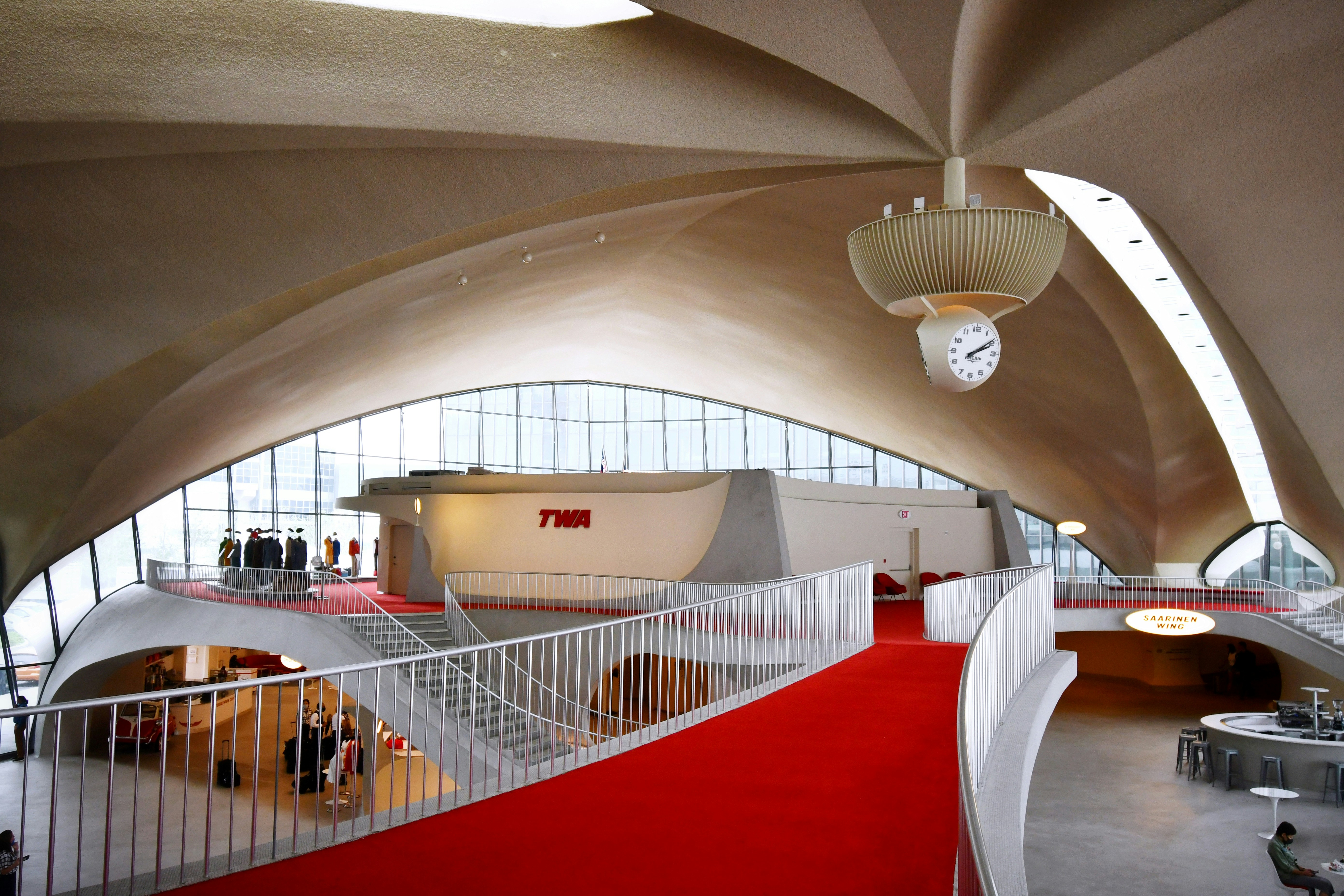 a red carpeted floor in a large building, The lobby of the TWA hotel
