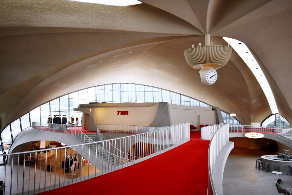 a red carpeted floor in a large building