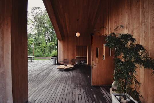 brown wooden bench near green leaf plant