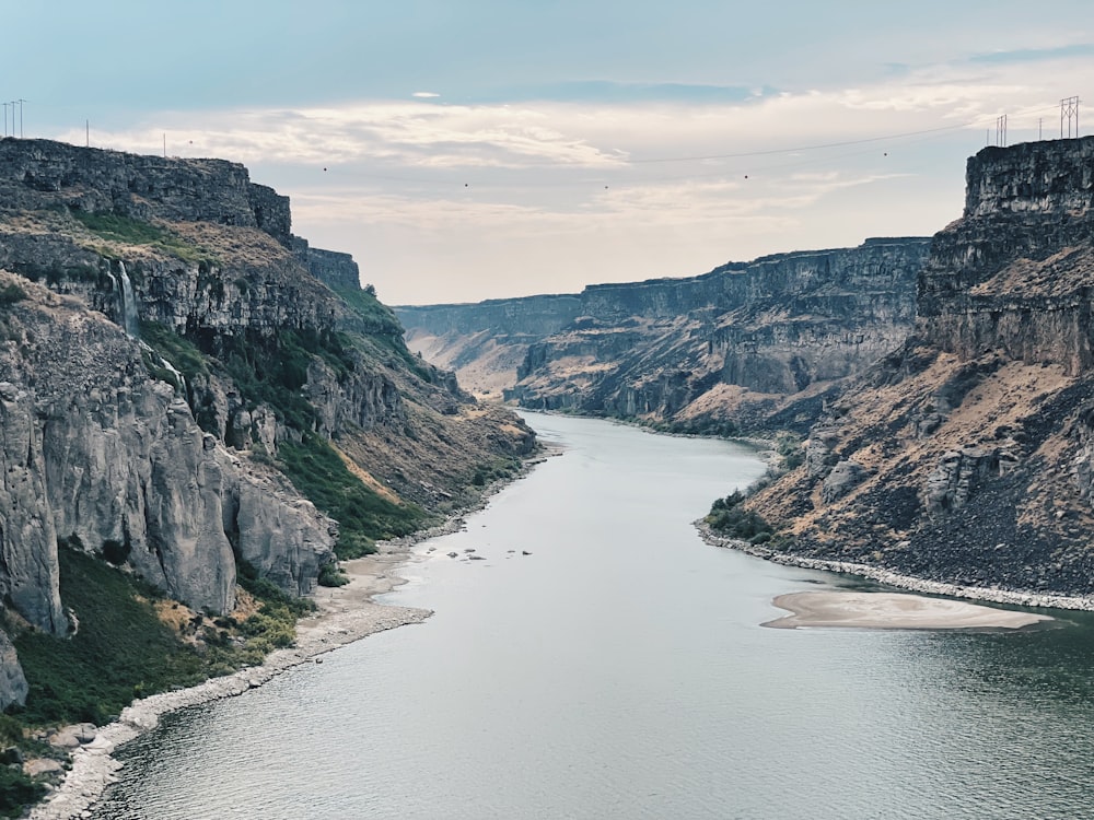 river between mountains during daytime