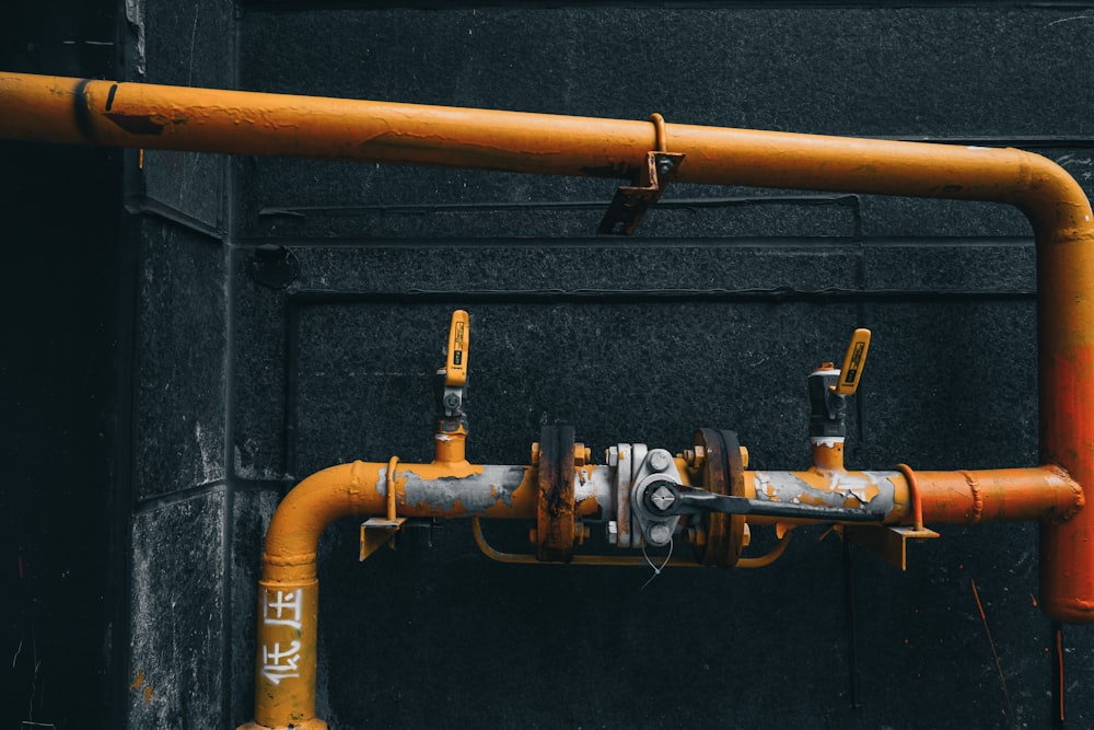 brass pipe with pipe on black wall