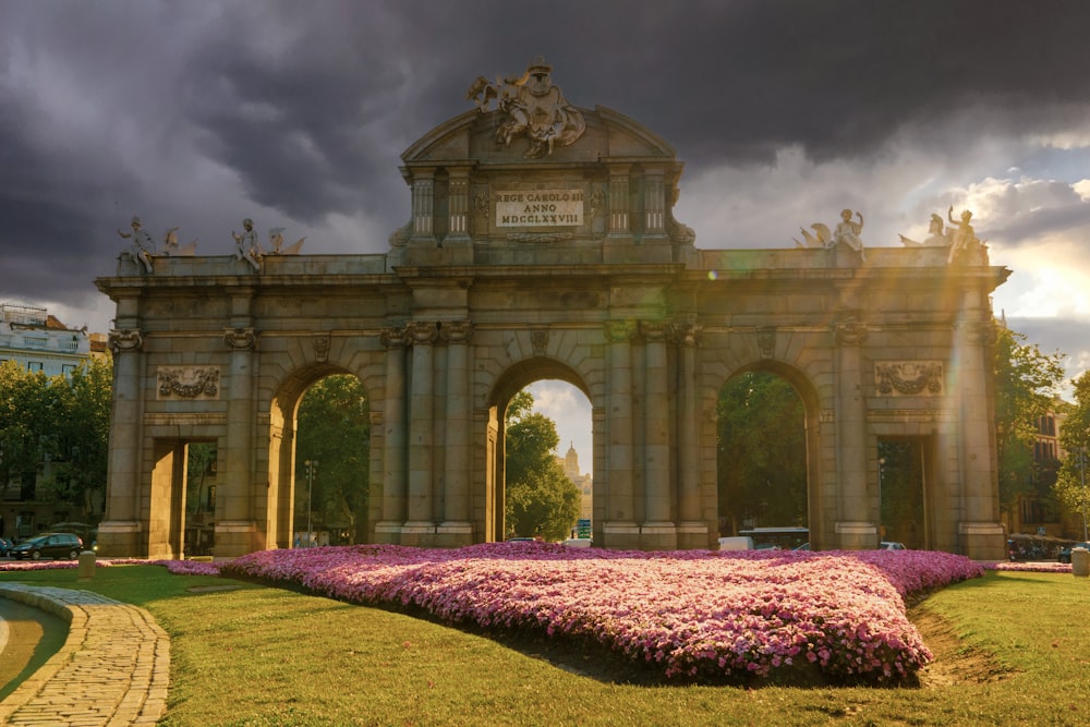 brown concrete arch under cloudy sky during daytime