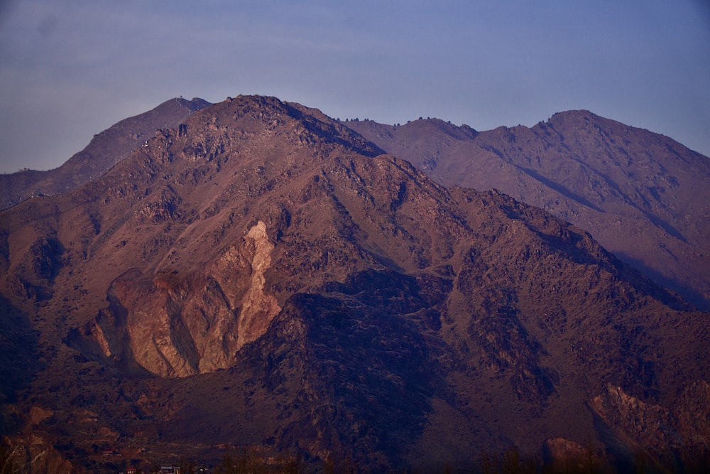 brown and black mountains under blue sky during daytime